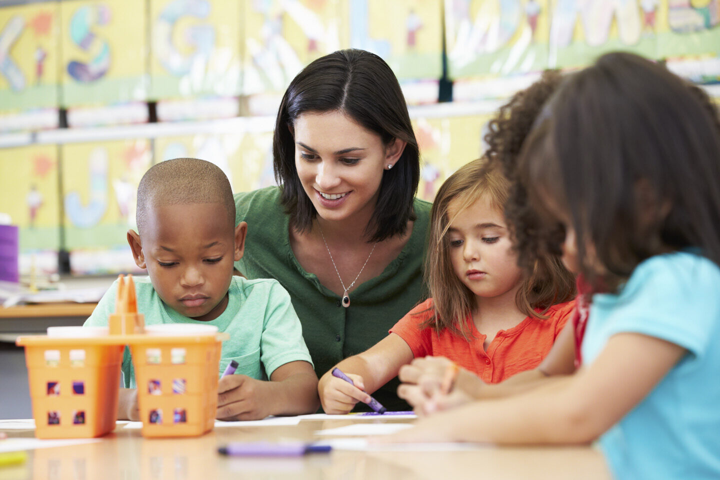 teacher watching her class colour